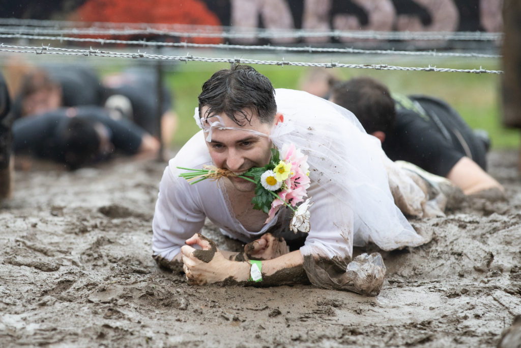 man with flowers in mud