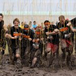 Participants clinging to each other's arms as they cross the Electroshock Therapy