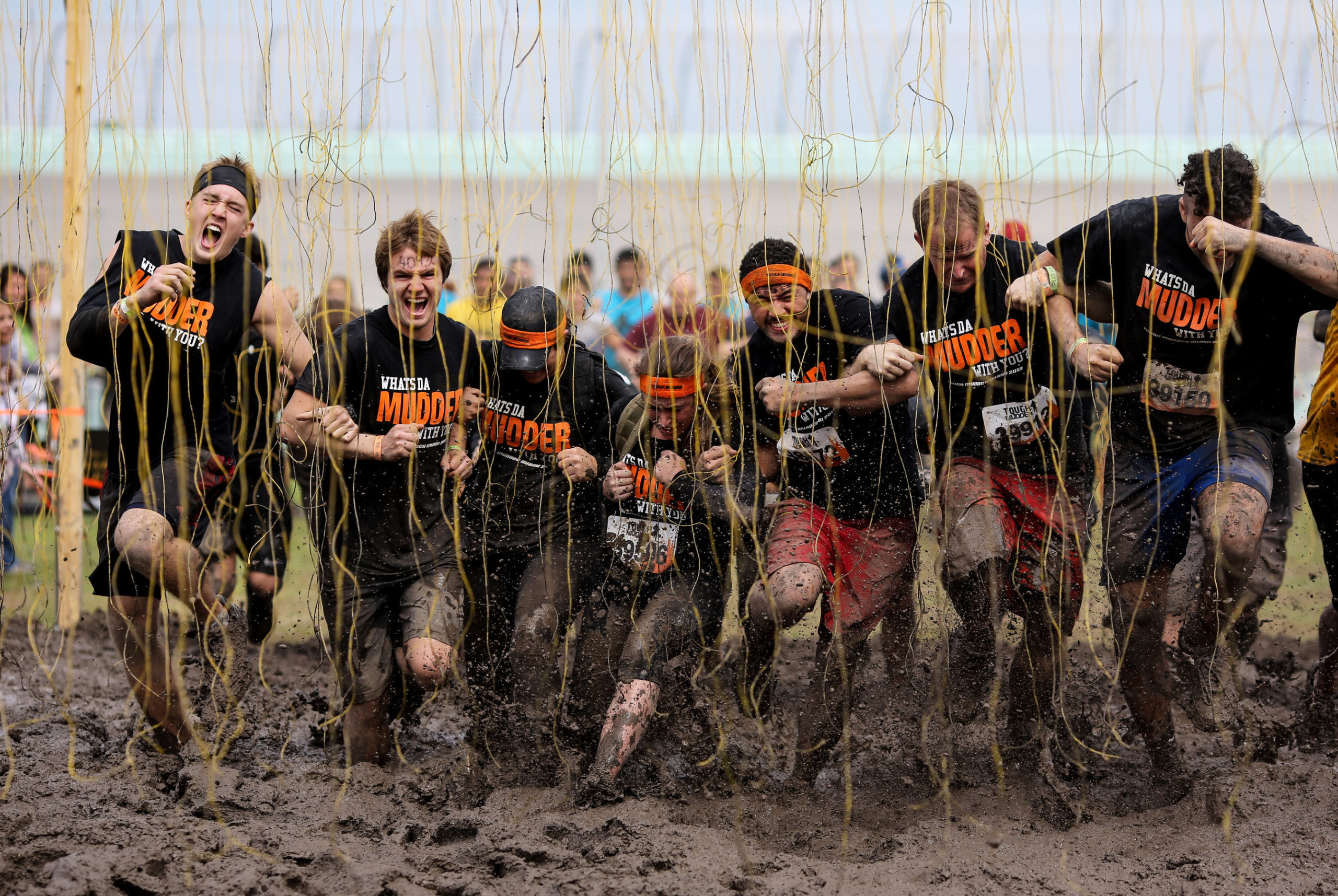 Participants clinging to each other's arms as they cross the Electroshock Therapy