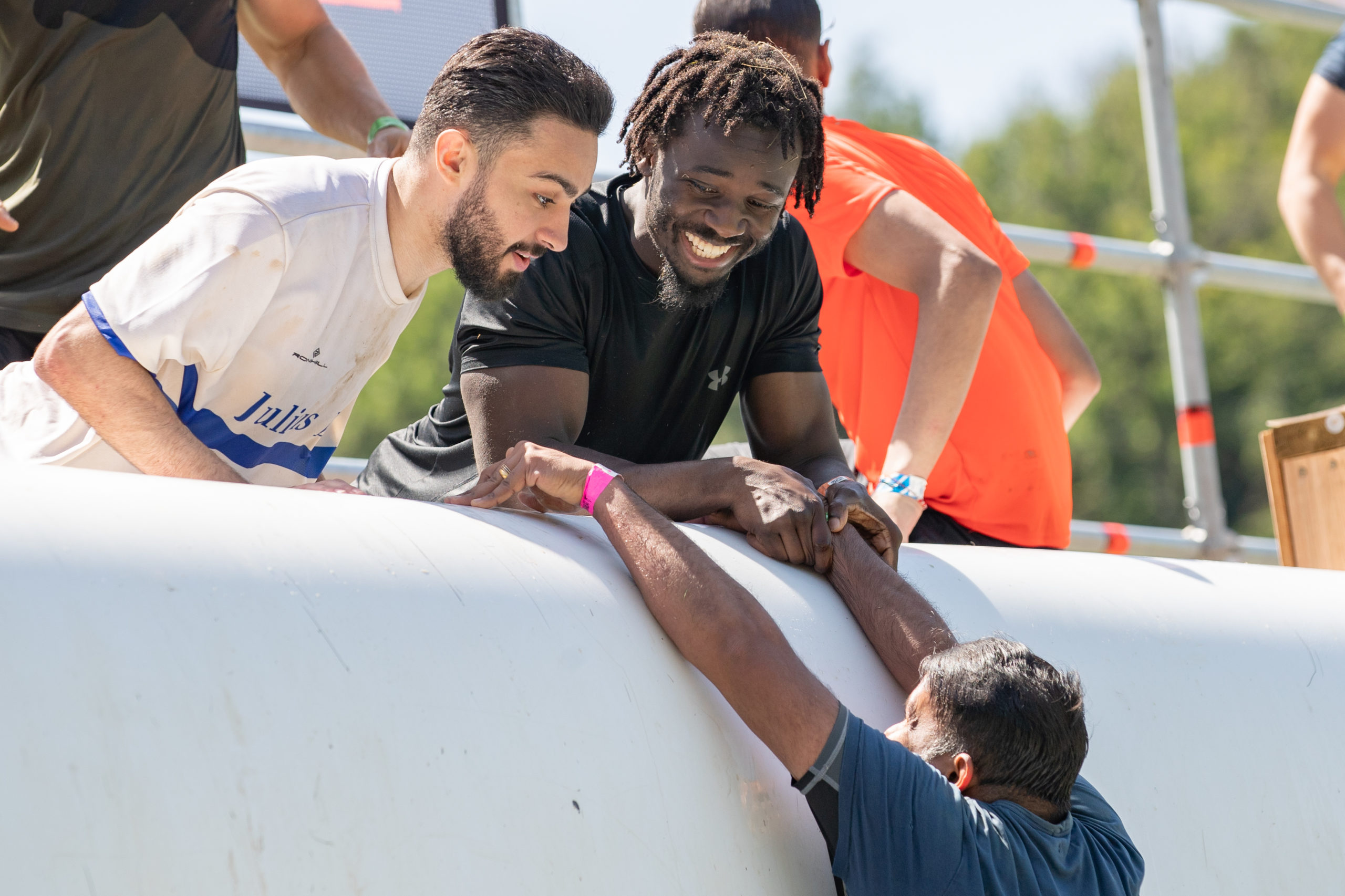 Participant grabbing on his teammates to climb the top of Everest