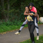 Participant carrying her partner in her back