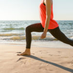 Woman doing yoga in the beachside