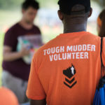 Volunteer wearing his Tough Mudder Volunteer Shirt