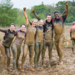 Participants covered in mud