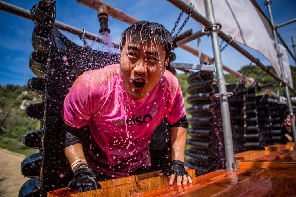 man in pink on Tough Mudder obstacle