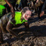 girl laughing in mud at north west event