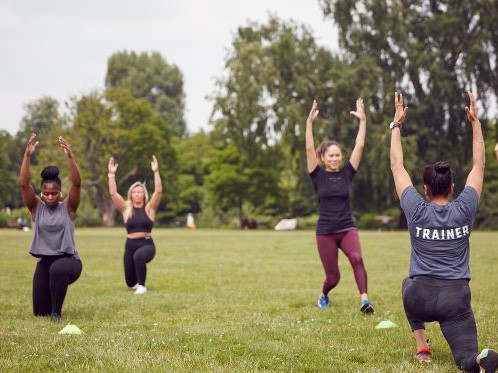 Participants kneeling with their hands in the air