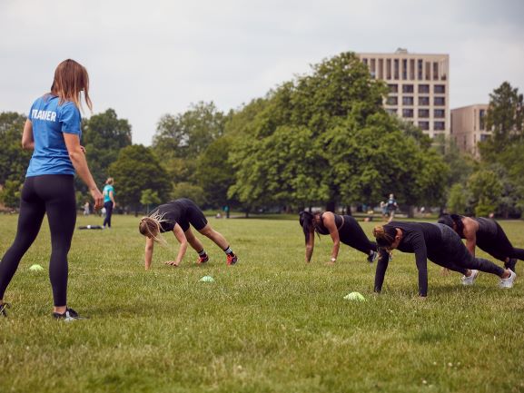 Participants doing planking while the Trainer is watching them