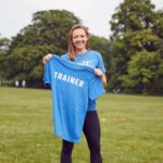 Woman showing off her Trainer Shirt