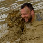 man splashing in mud.