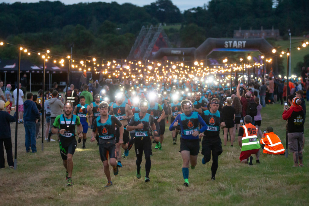 group running in dark with lights