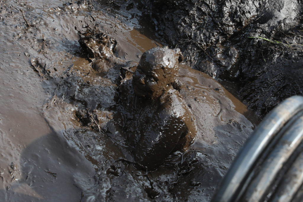 man fully in mud