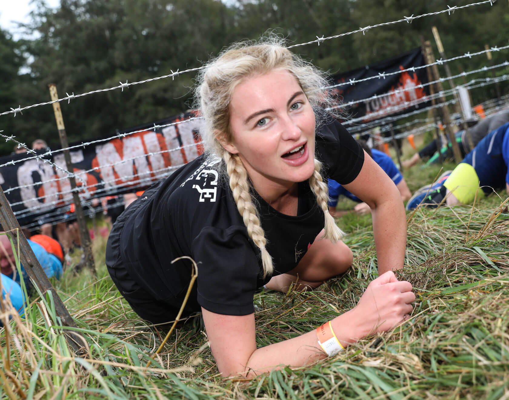 Participant crawling under the barbed wires