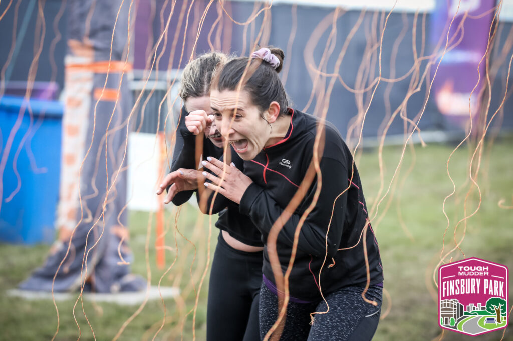 two girls running through Finsbury park event obstacle