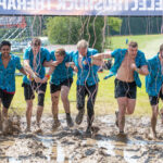 team running obstacle at London West event