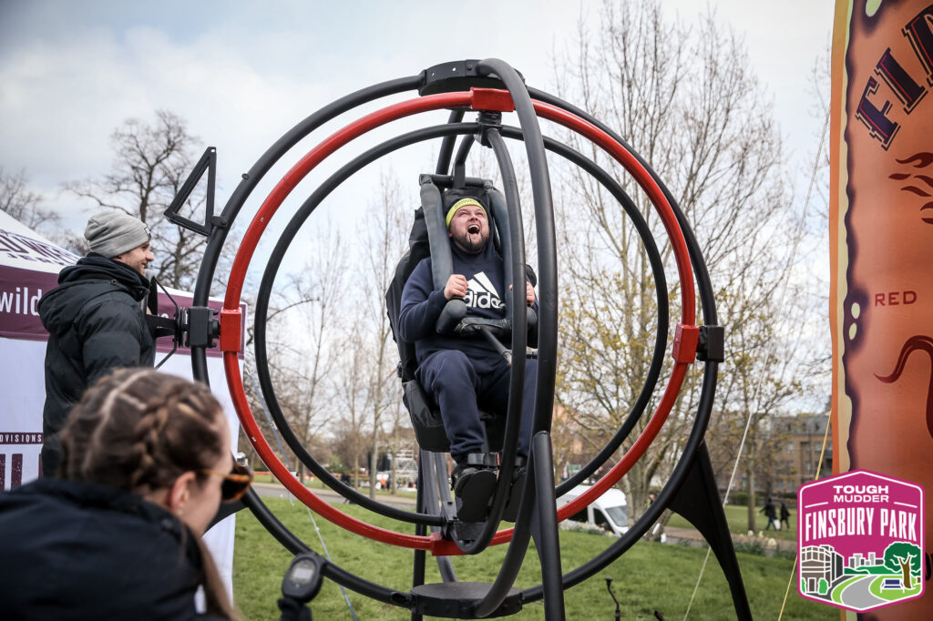 man in anti-gravity chair at event 