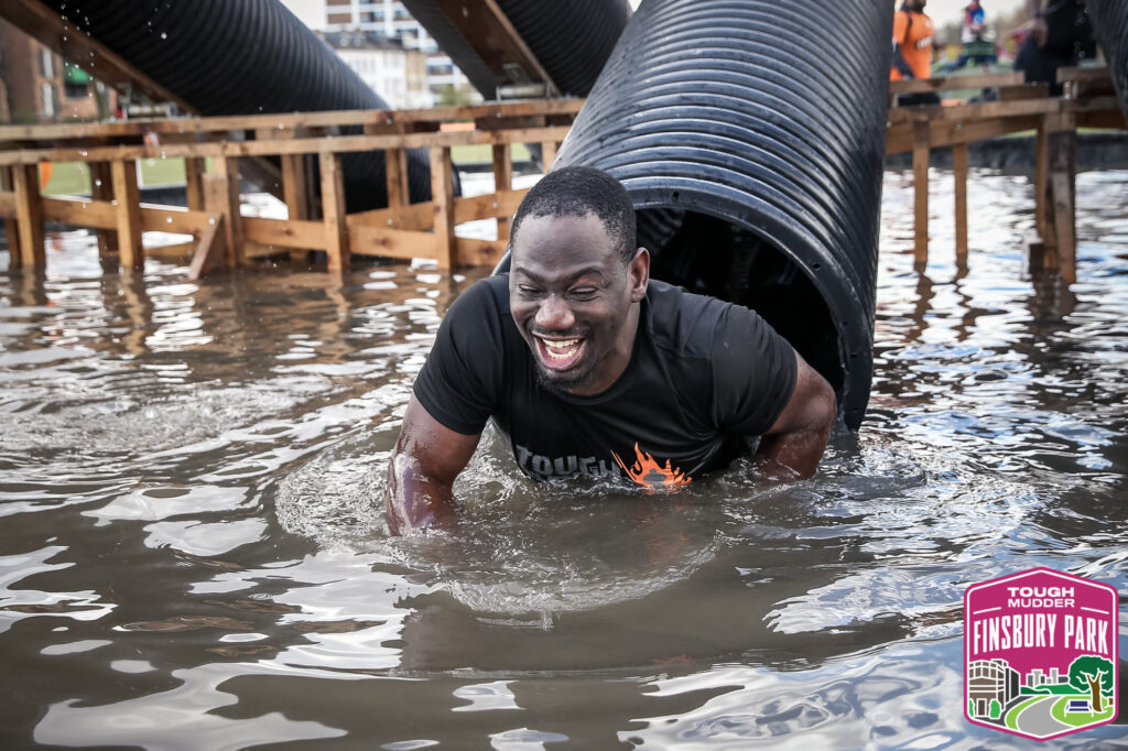 man coming of water obstacle smiling 