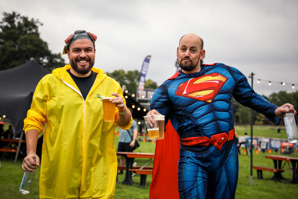 two men walking with beers in fancy dress at Tough Mudder